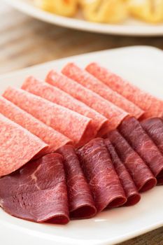 Party appetizer platter of salami and besaola italian meats.