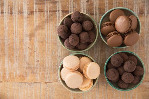 Flat lay of chocolate truffles and macaroons with copy space
