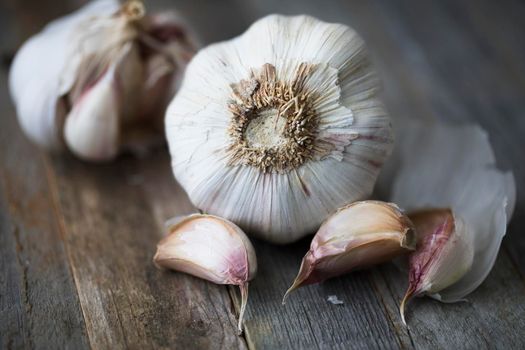 Garlic heads and cloves on wooden table