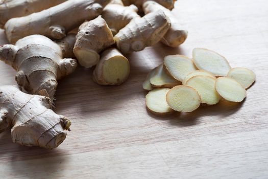 Ginger root and slices on cutting board