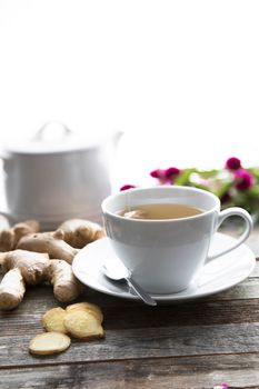 Ginger tea with ginger roots and slices on table