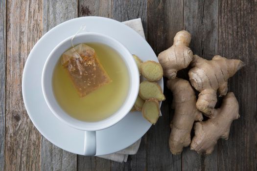 Ginger tea with ginger roots and slices viewed from directly above.