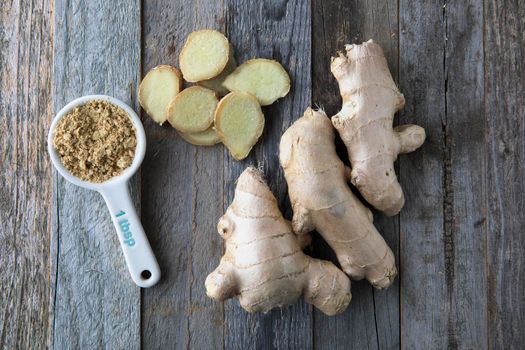 Ginger root, slices, and powder viewed from above.
