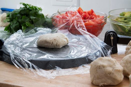 Making tortillas with masa marina flour dough and tortilla press