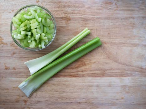 Celery stalks and slices on cutting board