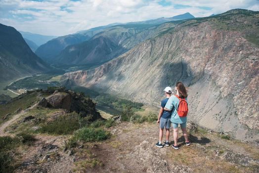 Woman an her son on the viewpoint of valley of the river of Chulyshman. Altai mountains, Russia, beautiful summer day, Travel concept