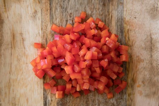 Diced red bell peppers on cutting board.