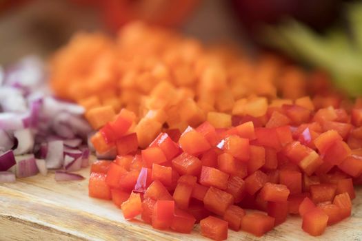 Diced red bell peppers on cutting board.