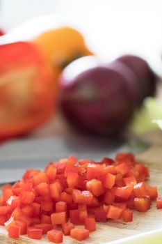 Diced red bell peppers on cutting board.