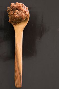 Small wooden spoon with red miso paste