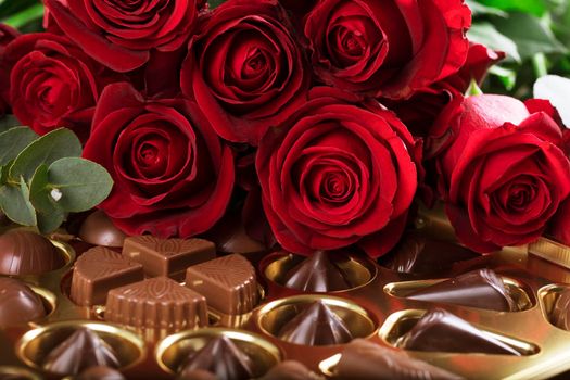 Vibrant red roses on a box of chocolates for valentine's day, or any day to say I love you.