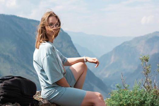 Domestic tourism, travel, lesure and freedom concept after pandemic- woman on the top of Altai mountain, beauty summer evening landcape