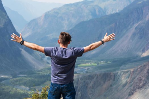 Domestic tourism, travel, lesure and freedom concept after pandemic- Man on the top of Altai mountain, beauty summer evening landcape