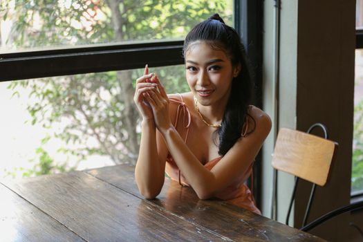 elegant sensual young woman in brown dress on recamier outdoor shot