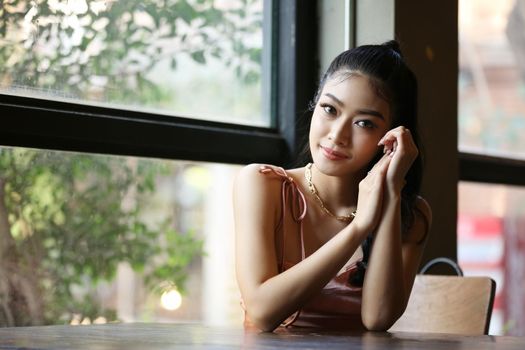 elegant sensual young woman in brown dress on recamier outdoor shot