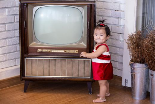 Full Length Of Cute Baby Girl Wearing Santa Costume While Sitting With Christmas Decorations