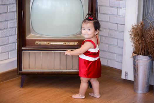 Full Length Of Cute Baby Girl Wearing Santa Costume While Sitting With Christmas Decorations