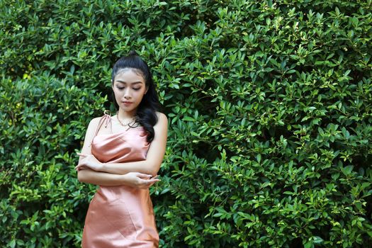 elegant sensual young woman in brown dress on recamier outdoor shot