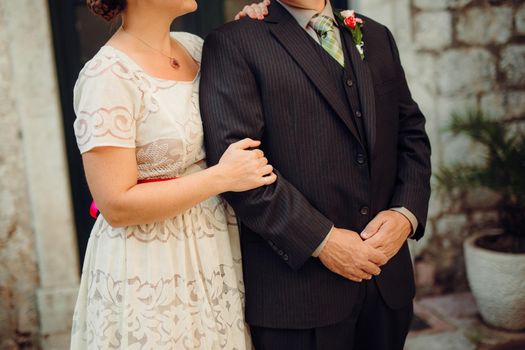 Bride and groom at wedding Day walking Outdoors on spring nature. Bridal couple, Happy Newlywed woman and man embracing in green park. Loving wedding couple outdoor. Bride and groom