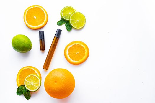 Cosmetic roller oil and citrus fruits . Cosmetic procedures. Healthy skin. Skin care. Citrus oil. White background. Copy space. Article about care cosmetics