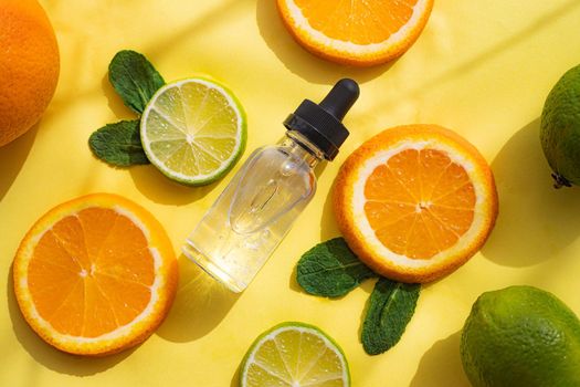 Hyaluronic acid and citrus fruits . Cosmetic procedures. Healthy skin. Skin care. Citrus oil. Yellow background. Copy space. Article about care cosmetics