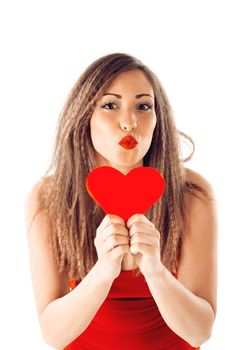 Beautiful smiling girl holding a red heart and sending a kiss. Looking at camera.