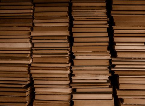 Four stacks of old books. Vintage styled background.