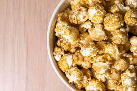 a cup of popcorn on a wooden background . place for the label. High quality photo