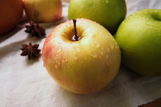 Fresh apples and anise on the linen cloth.