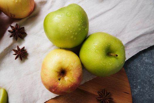 Fresh apples and anise on the linen cloth.