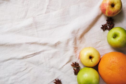 Fresh apples, grapefruit and anise on the linen cloth.