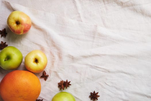 Fresh apples, grapefruit and anise on the linen cloth.