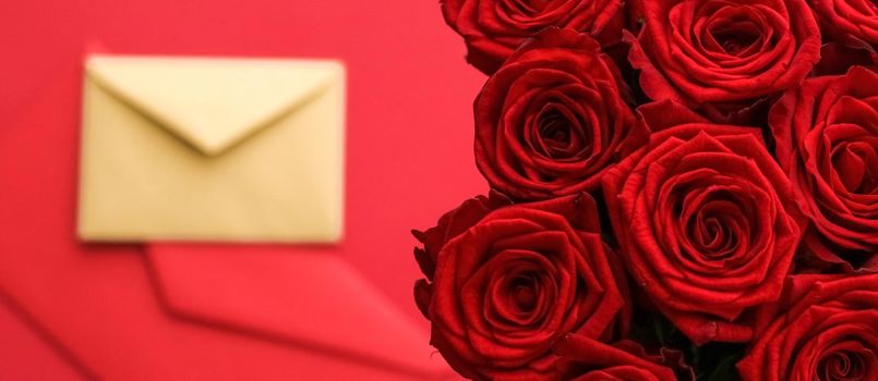 Holiday gift, flowers flatlay and happy relationship concept - Love letter and flower delivery service on Valentines Day, luxury bouquet of red roses and card envelopes on red background