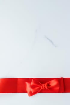 Holiday decor, feminine design and flatlay concept - Red silk ribbon on marble, top view