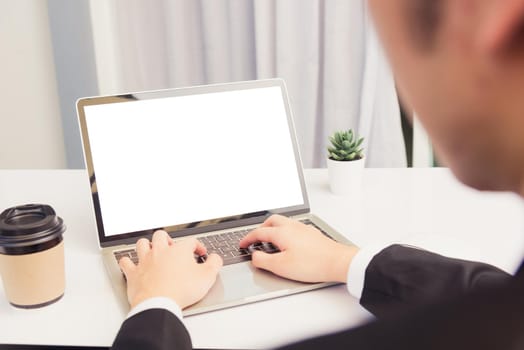 Work from home, Asian young businessman smile wearing suit video conference call or facetime by laptop computer sitting and listening to teammates explained on desk at home office