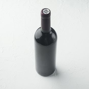 Wine bottle set, square format, on white stone background