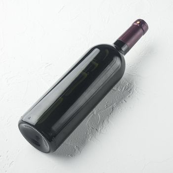 Wine bottle set, square format, on white stone background