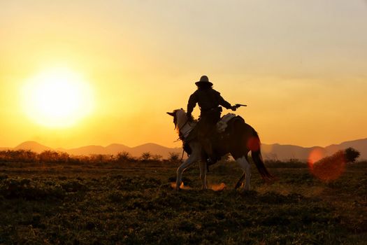 cowboy and horse at first light,mountain, river and lifestyle with natural light background	