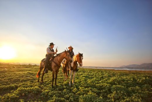 cowboy and horse at first light,mountain, river and lifestyle with natural light background	