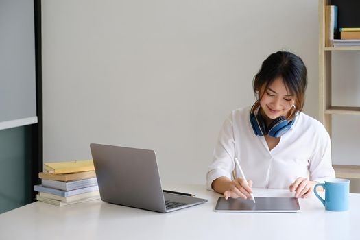 A girl practice basic course exercises by video on laptop before online class. Social distancing.stay home. New normal. Covid-19 coronavirus concept.