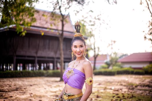 Beautiful woman, Thai national costume, traditional Thai dress, Thai woman, good mood, beautiful smile background - Image with noise and grain