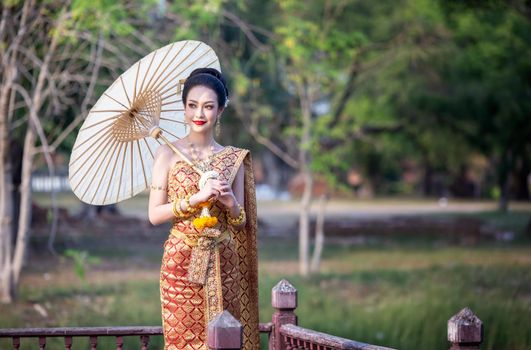 Beautiful woman, Thai national costume, traditional Thai dress, Thai woman, good mood, beautiful smile background - Image with noise and grain