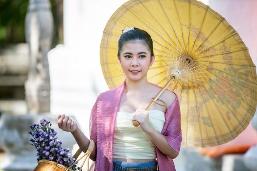 Lanna woman north thailand, Thailand or Thai costume Asian dress concept. Young Thai beautiful woman is walking in the Buddhist temple in Ayutthaya.