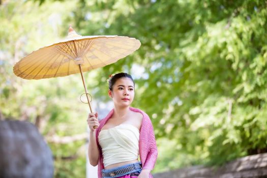 Lanna woman north thailand, Thailand or Thai costume Asian dress concept. Young Thai beautiful woman is walking in the Buddhist temple in Ayutthaya.