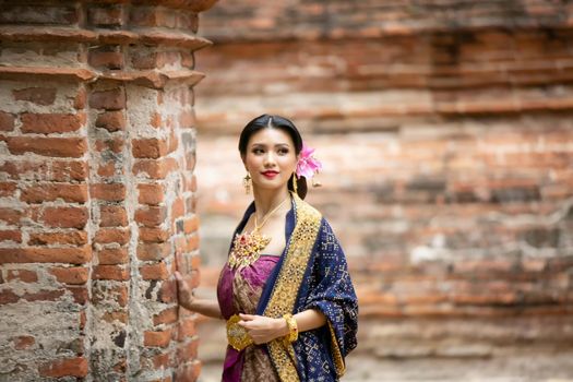 Indonesia Young beautiful woman with Traditional dress standing and look at camera at Gate to heaven Handara Golf Gate in Bedugul, Bali ,Indonesia.