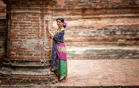 Indonesia Young beautiful woman with Traditional dress standing and look at camera at Gate to heaven Handara Golf Gate in Bedugul, Bali ,Indonesia.