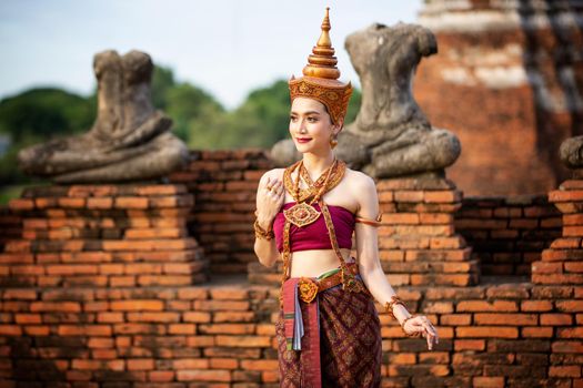 Beautiful woman, Thai national costume, traditional Thai dress, Thai woman, good mood, beautiful smile background - Image with noise and grain