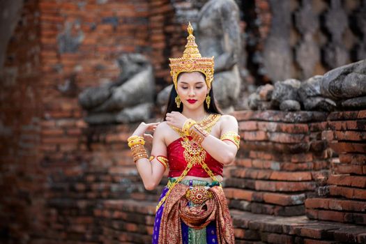 Beautiful woman, Thai national costume, traditional Thai dress, Thai woman, good mood, beautiful smile background - Image with noise and grain