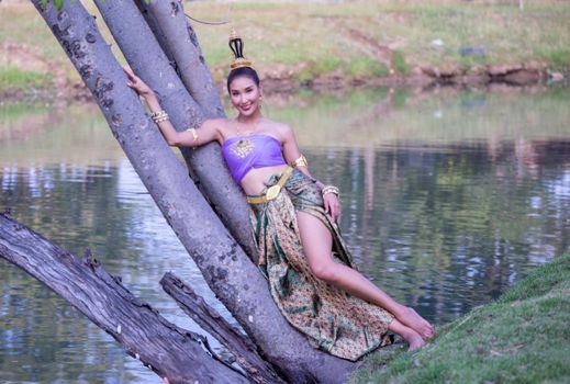 Beautiful woman, Thai national costume, traditional Thai dress, Thai woman, good mood, beautiful smile background - Image with noise and grain