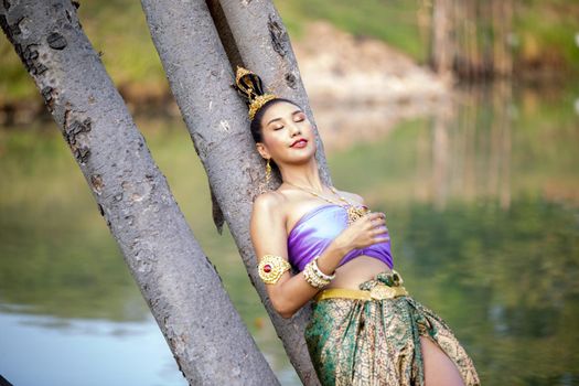 Beautiful woman, Thai national costume, traditional Thai dress, Thai woman, good mood, beautiful smile background - Image with noise and grain